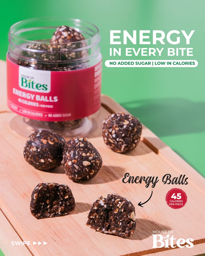 Energy balls on a wooden board in front of an open House of Bites jar, with the words energy in every bite.