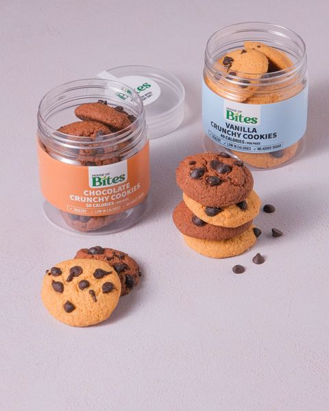Chocolate and vanilla crunchy cookie jars with a stack of cookies and chocolate chips.